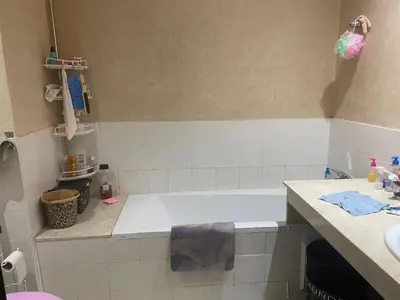 a bathroom with a white tub and a sink at Garden beach 2 in Sidi Rahal