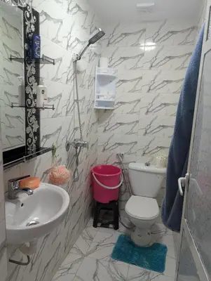 a bathroom with a white toilet and a sink at Guesthouse Skhirat in Skhirat