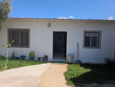 a white house with a black door and windows at Guesthouse Skhirat in Skhirat
