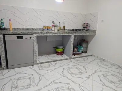a kitchen with a counter and a dishwasher at Guesthouse Skhirat in Skhirat