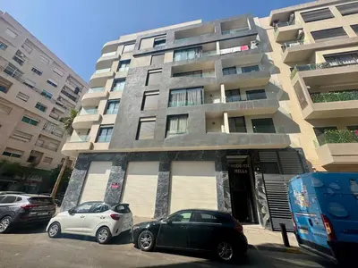 two cars parked in front of a building at Scandi Design Central Casablanca in Casablanca