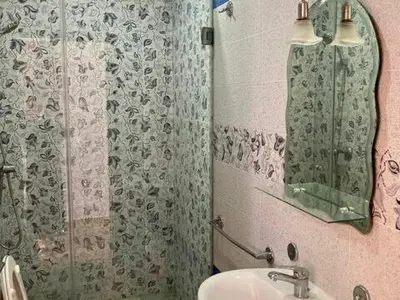 a bathroom with a shower and a sink and a mirror at Belle et spacieuse villa avec piscine privée in Casablanca