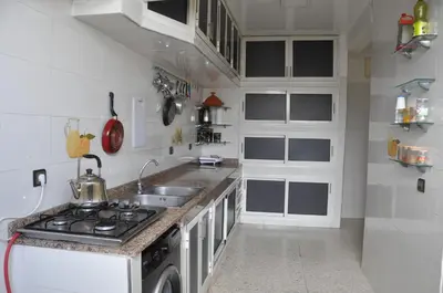 a white kitchen with a sink and a stove at Rental Apartment in Casablanca City Center in Casablanca