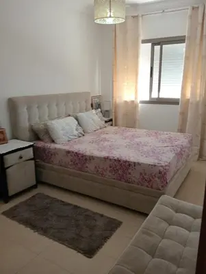 a bedroom with a large bed and a window at 2 Bedrooms Blanca Beach in Sidi Rahal