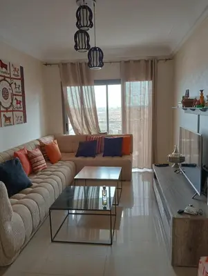 a living room with a couch and a table at 2 Bedrooms Blanca Beach in Sidi Rahal