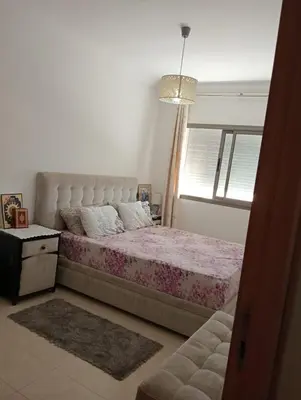 a bedroom with a large bed and a window at 2 Bedrooms Blanca Beach in Sidi Rahal