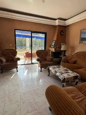 a living room with couches and a table in a room at Appartement pour la CAN, Palm Beach - Mansouria in Mohammedia