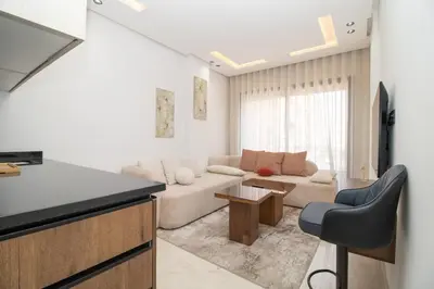 a living room with a couch and a table at Modern Studio 5min CFC in Casablanca