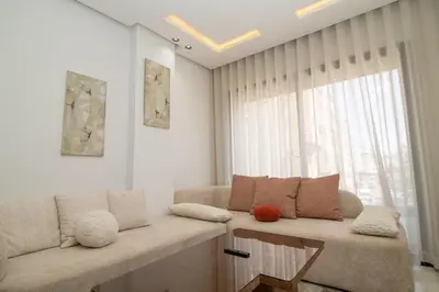a living room with a couch and a window at Modern Studio 5min CFC in Casablanca