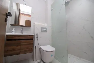 a bathroom with a toilet and a sink and a mirror at Modern Studio 5min CFC in Casablanca