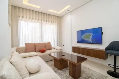 a living room with a couch and a tv at Modern Studio 5min CFC in Casablanca