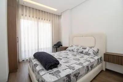 a bedroom with a bed with a cat sleeping on it at Modern Studio 5min CFC in Casablanca