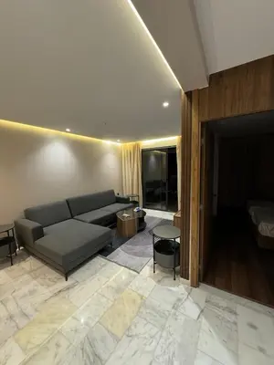 a living room with a couch and a bed at Luxury Apartment 5min CFC in Anfa