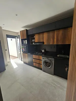 a kitchen with a washer and a washing machine at Luxury Apartment 5min CFC in Anfa