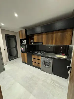 a kitchen with a sink and a washing machine at Luxury Apartment 5min CFC in Anfa