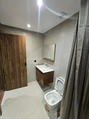 a bathroom with a toilet and a sink and a mirror at Luxury Apartment 5min CFC in Anfa