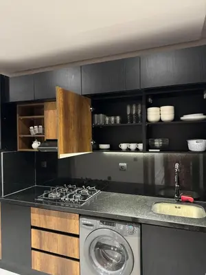 a kitchen with a stove and a washing machine at Luxury Apartment 5min CFC in Anfa