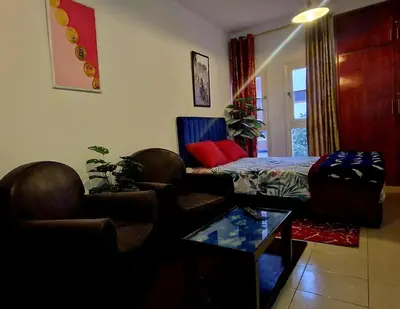 a living room with a couch and a bed at Parisien Studio in Rabat