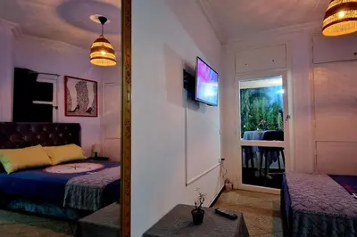 a mirror reflecting a bedroom with a bed and a window at Nice studio for nice people in Rabat