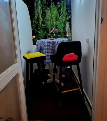 a table with two stools in front of a table with a tableablishthritis at Nice studio for nice people in Rabat