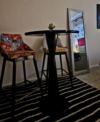 a table and two chairs in a living room at Greeny Studio in Rabat