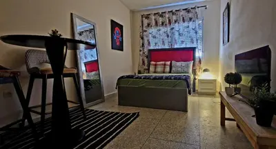 a bedroom with a bed and a window at Greeny Studio in Rabat
