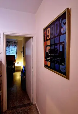 a painting hanging on a wall in a hallway at Greeny Studio in Rabat