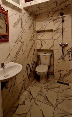 a stone bathroom with a toilet and a sink at Greeny Studio in Rabat