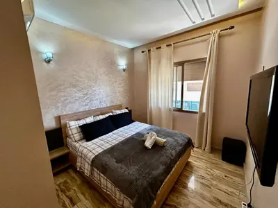 a bedroom with a bed with a teddy bear on it at Ocean side - Prestige & Douceur familliale in Casablanca