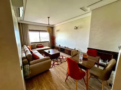 a living room with a couch and a table at Ocean side - Prestige & Douceur familliale in Casablanca