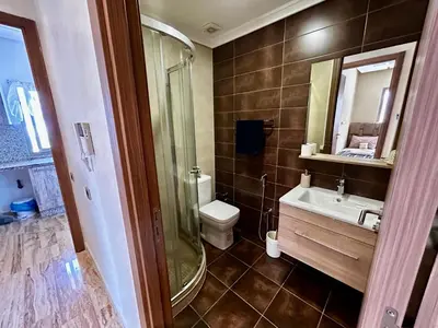 a bathroom with a toilet and a sink and a shower at Ocean side - Prestige & Douceur familliale in Casablanca