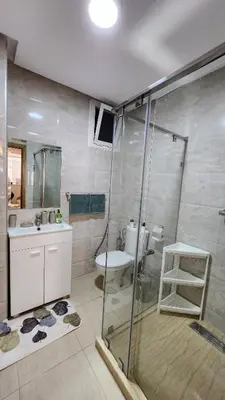 a bathroom with a shower and a sink and a toilet at Cosy and central condo with terace steps to shore in Rabat