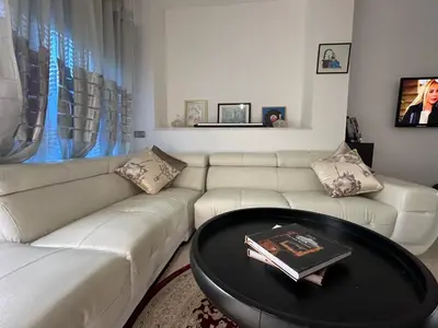 a living room with a white couch and a table at Maison ensoleillée à Skhirat, Piscine & Parking in Skhirat