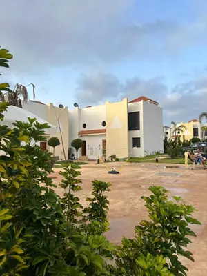 a large white building with a yard in front of it at Maison ensoleillée à Skhirat, Piscine & Parking in Skhirat
