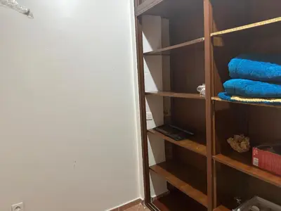 a closet with blue towels in a room at Appartement A Darbouazza Tamaris 5min accès a la plage in Tamaris