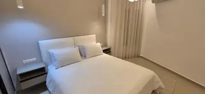 a bedroom with a white bed with two pillows at Rabat Residence - OCEAN STAY 2 in Rabat