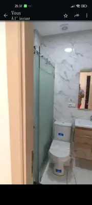a bathroom with a toilet and a shower and a sink at Nid d'anges in Bouznika