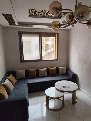 a living room with a couch and a table at Nid d'anges in Bouznika