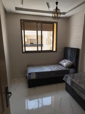 a bedroom with two beds and a window at Nid d'anges in Bouznika