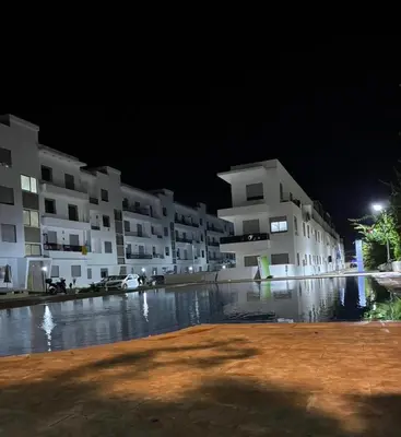 a group of apartment buildings at night at Apartment for rent el mansoria in Mansouria