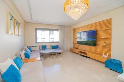 a living room with a couch and a tv at Bourgogne Bliss in Casablanca