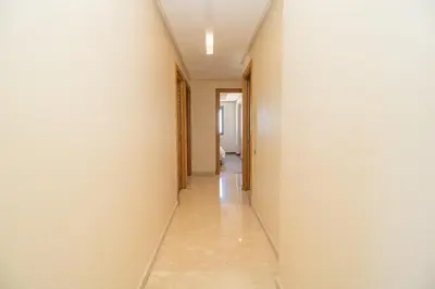 a hallway with white walls and a long corridor at Bourgogne Bliss in Casablanca