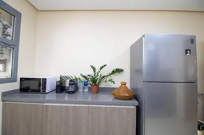 a kitchen with a refrigerator and a microwave at Bourgogne Bliss in Casablanca