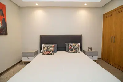 a bedroom with a large white bed with two pillows at Bourgogne Bliss in Casablanca