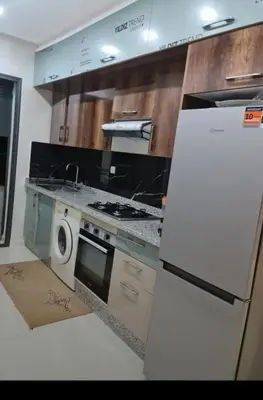 a kitchen with a refrigerator and a washing machine at Maison vacances à bouznika in Bouznika