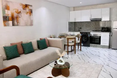 a living room with a couch and a kitchen at Holiday Harmony in Roches Noires