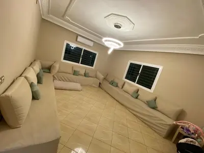 a living room with a large couch and two windows at Dream villa with a pool