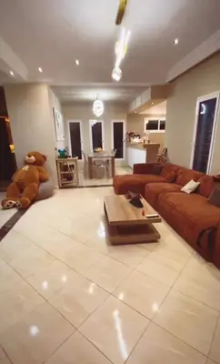 a large living room with a couch and a teddy bear at Dream villa with a pool