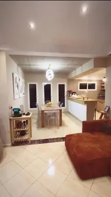 a large living room with a table and a kitchen at Dream villa with a pool