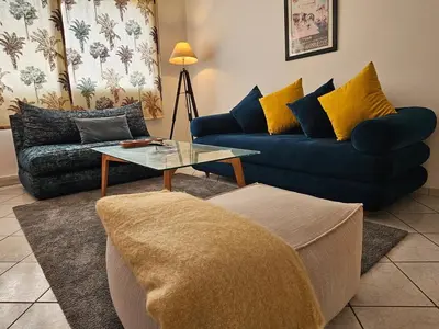 a living room with a couch and a coffee table at Maarif Central Stay in Maarif